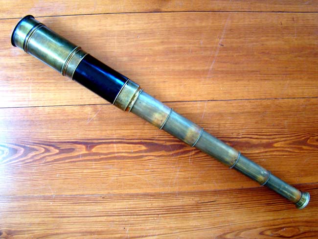 A 19th century English five-draw telescope with ebonized wood barrel circa 1860